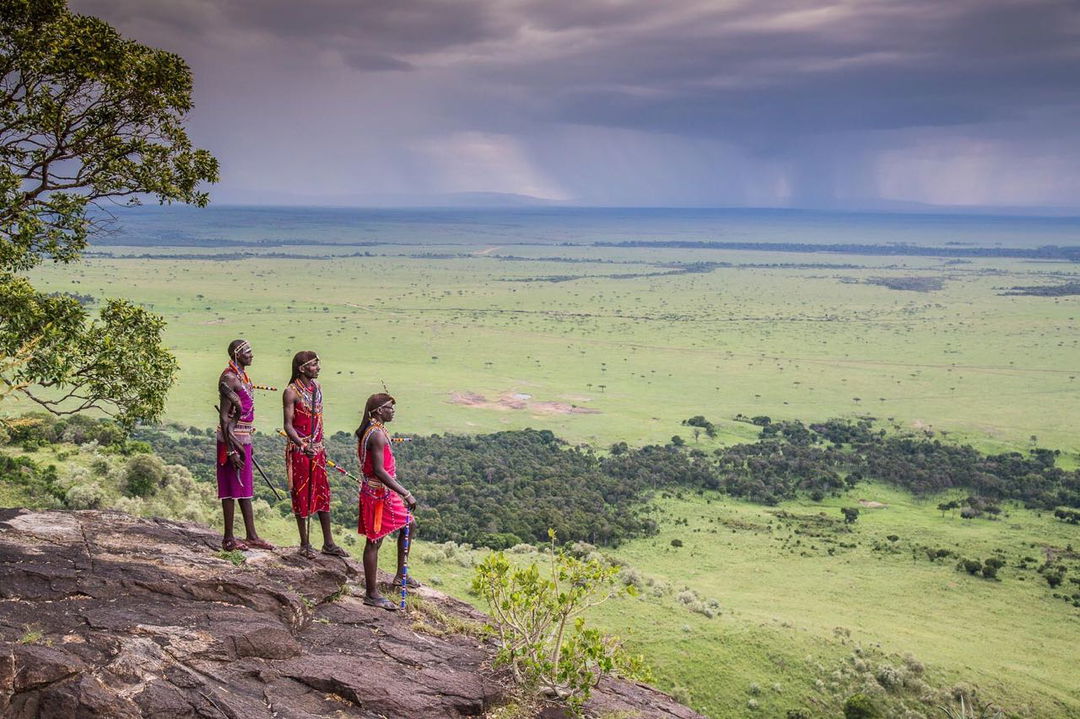 Masai rangers on a hilltop overlooking plains by Angama Mara Kenya Masai Mara