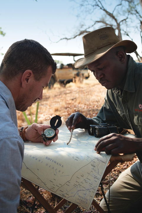 guest and guide reading a map on a bush walk at Belmond Eagle Island Lodge
