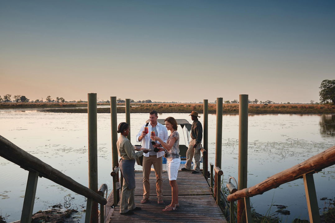 guests arriving by boat and welcomed on jetty by Belmond Eagle Island Lodge