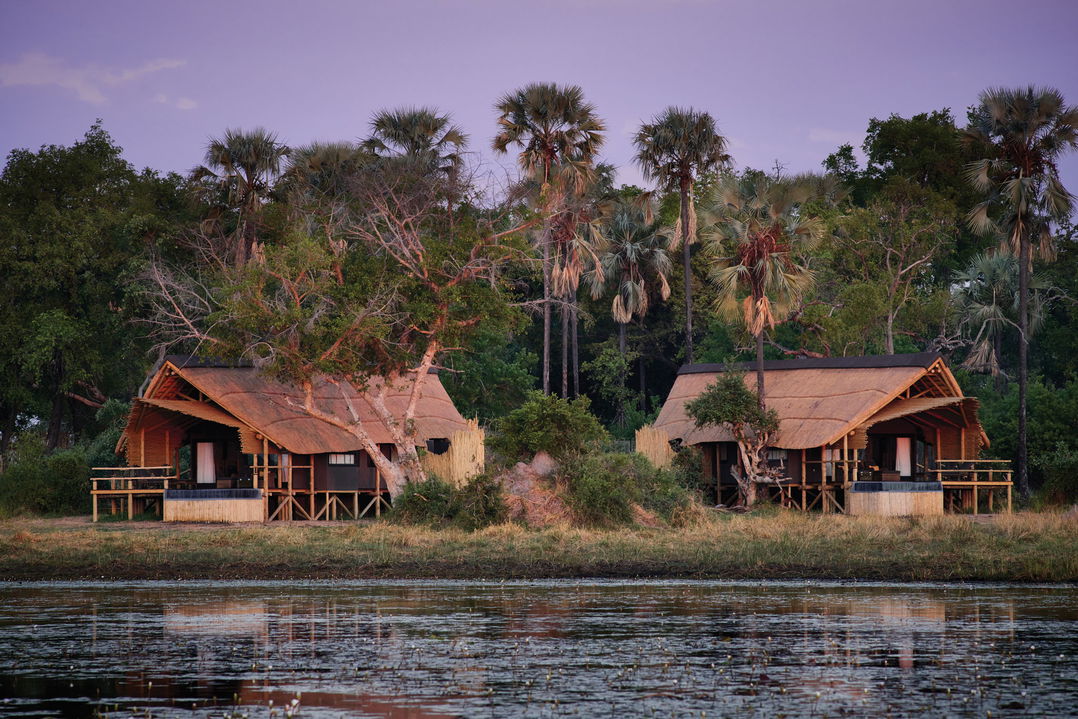 exterior view of luxury tented suites of Belmond Eagle Island Lodge and delta in foreground