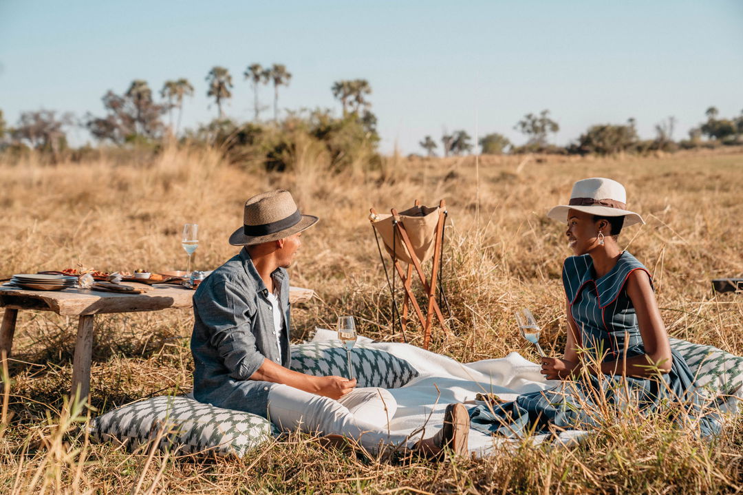 couple having a picnic in the Okavango delta by Belmond Eagle Island Lodge