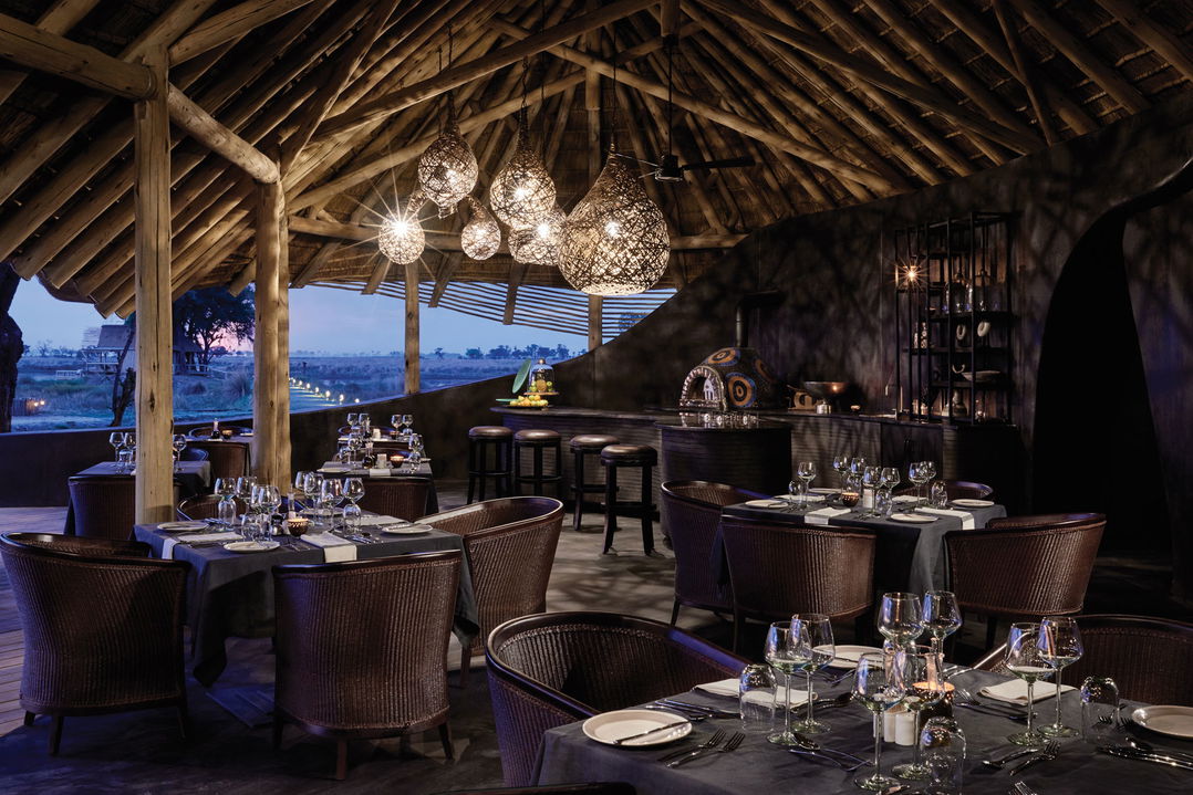 dining area at sunset by main lodge of Belmond Eagle Island Lodge