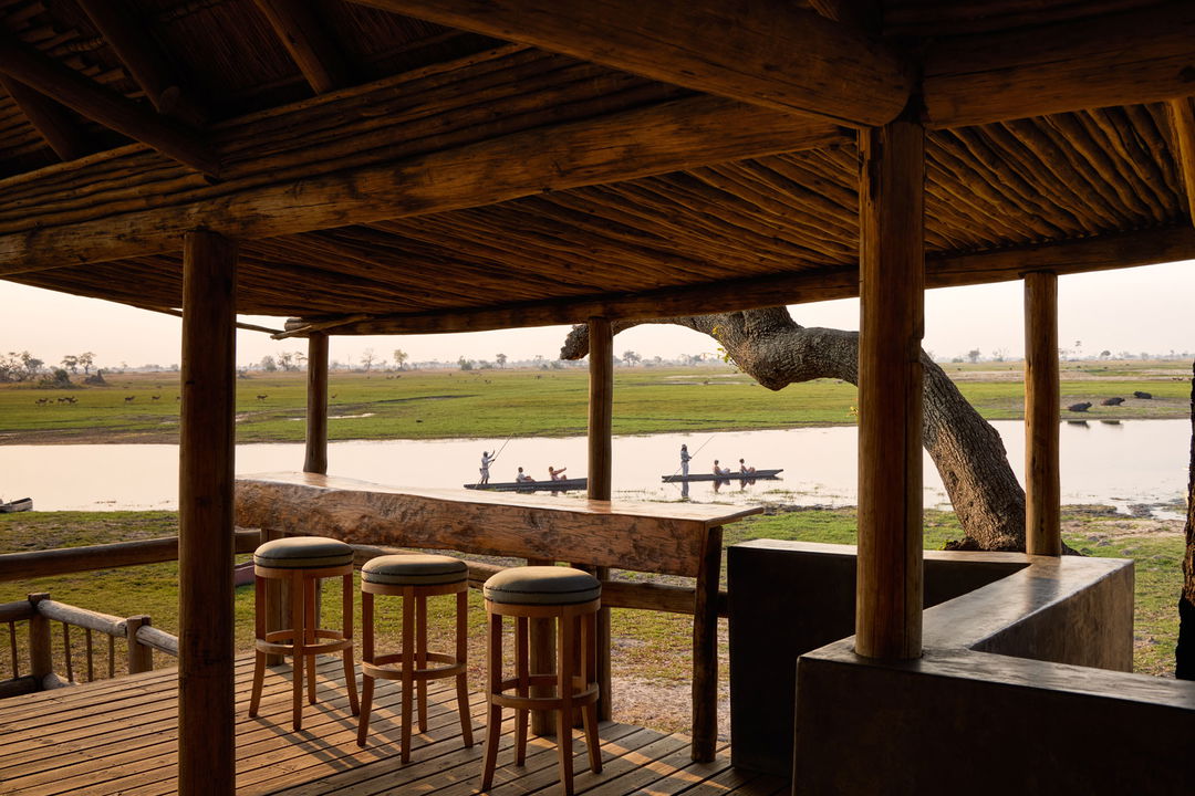 bar area with views of mokoros on delta at Belmond Eagle Island Lodge