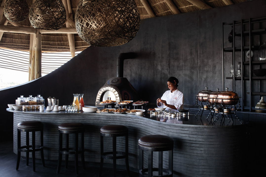 staff perparing food at serving counter of dining area at Belmond Eagle Island Lodge