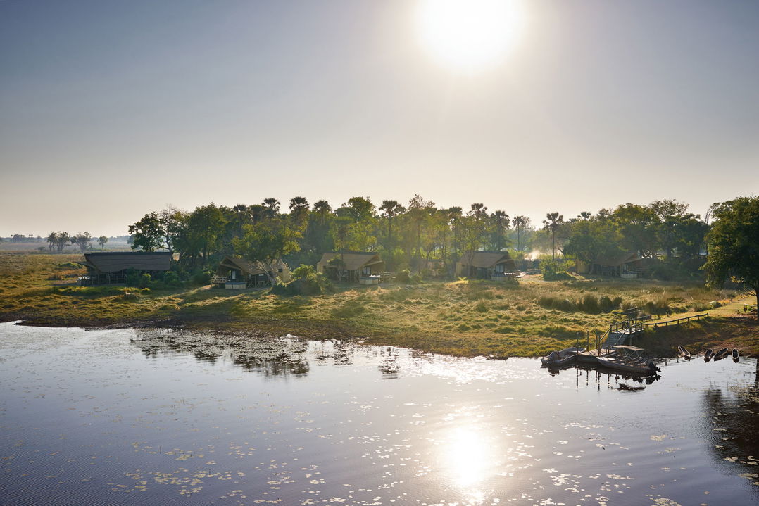 aerial view of Belmond Eagle Island Lodge with hippos in water
