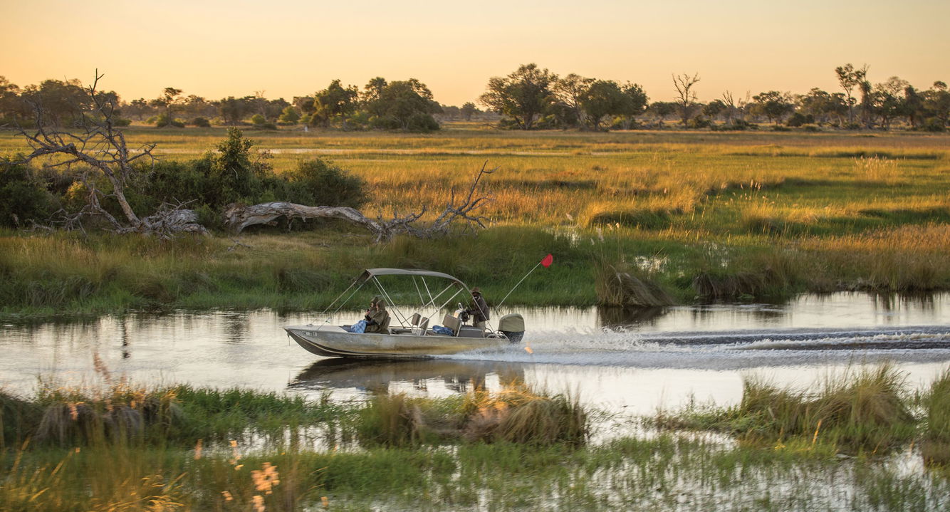 boat cruising on the Okavango delta waters at Belmond Eagle Island Lodge