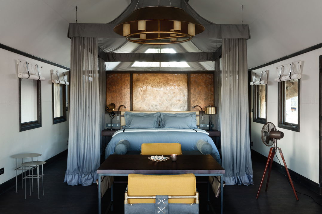 view of the bed in bedroom of luxury suite by Belmond Eagle Island Lodge