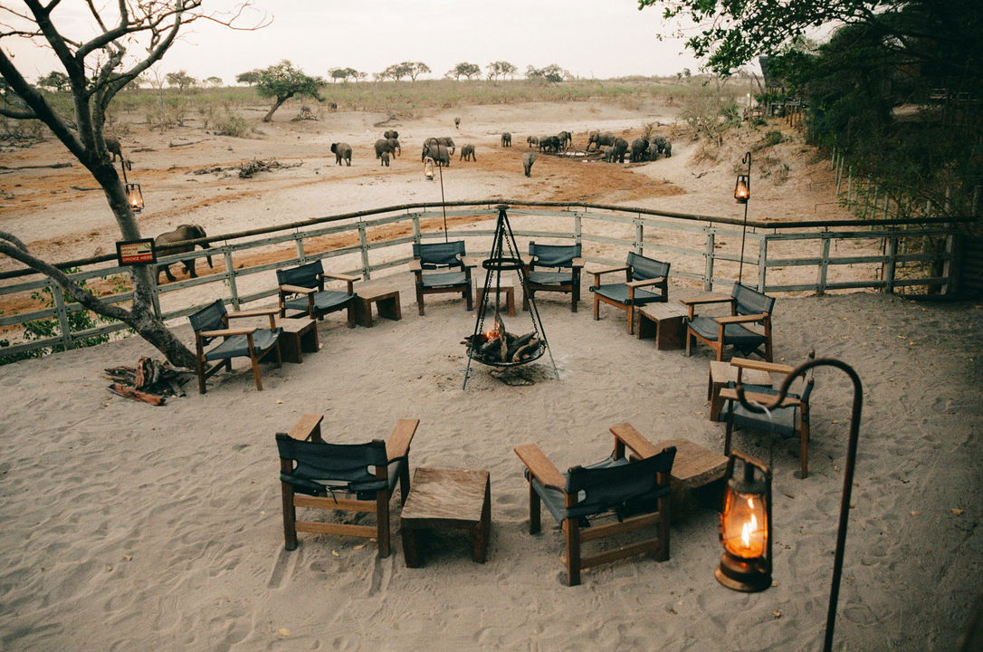 fireplace boma with elephants behind at waterhole by Savute elephant lodge Botswana