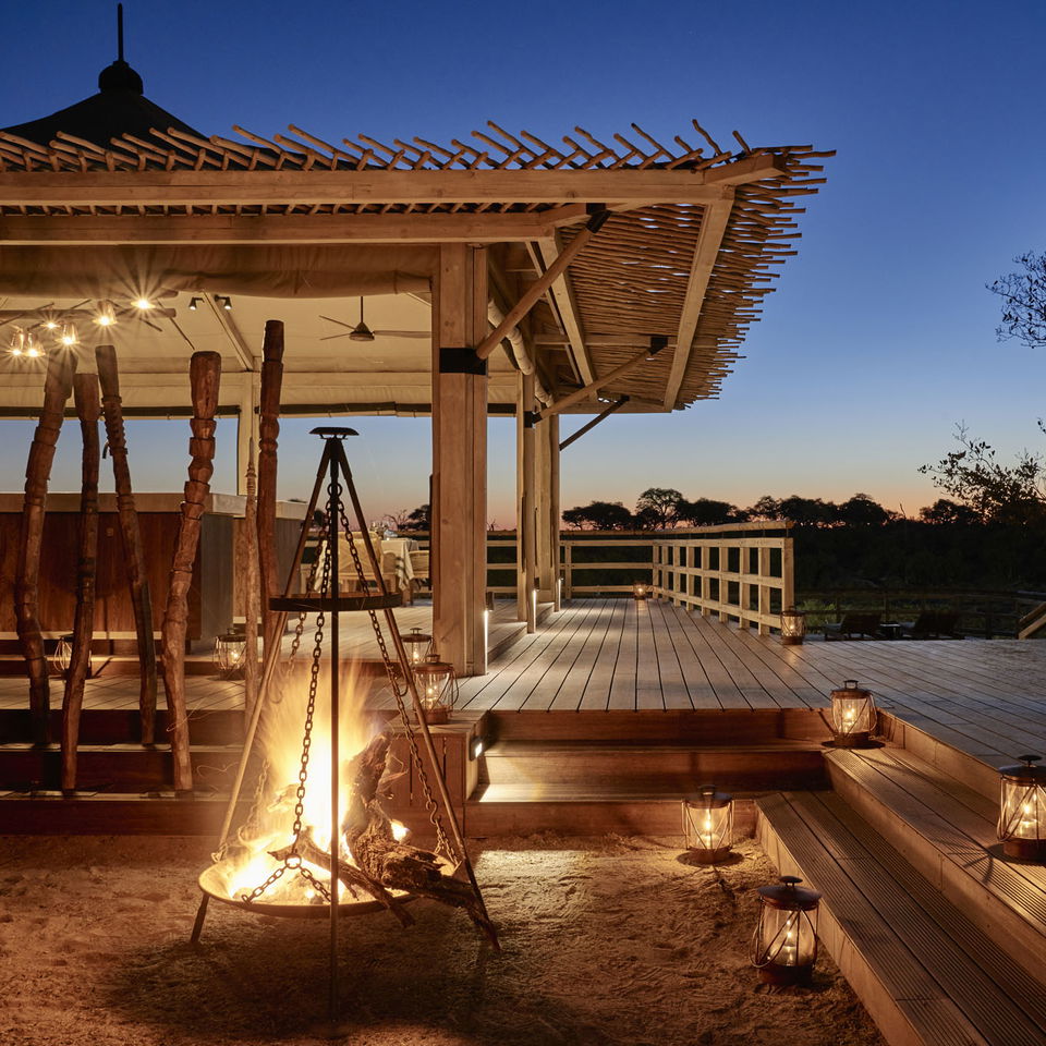 sunset view of fireplace with wooden deck in background Okavango delta Savute elephant lodge