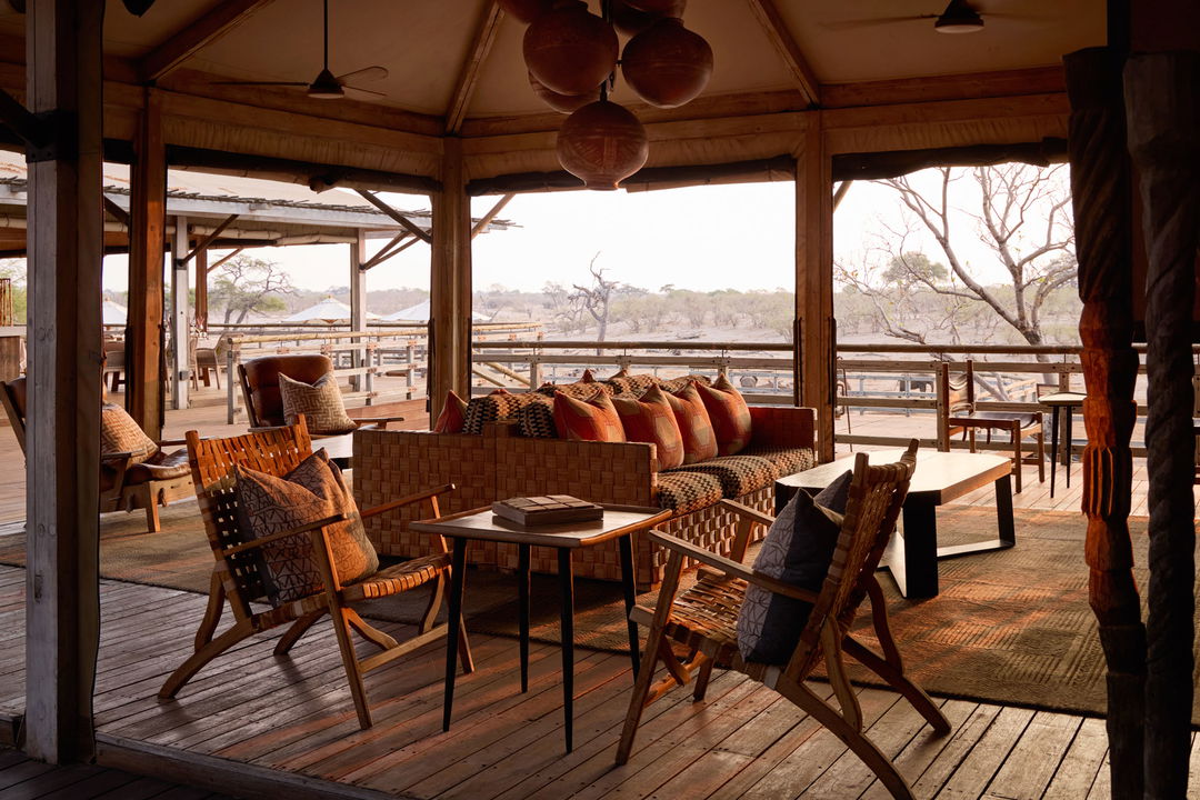 lounge with deck in background and African sunset view by Savute elephant lodge Botswana