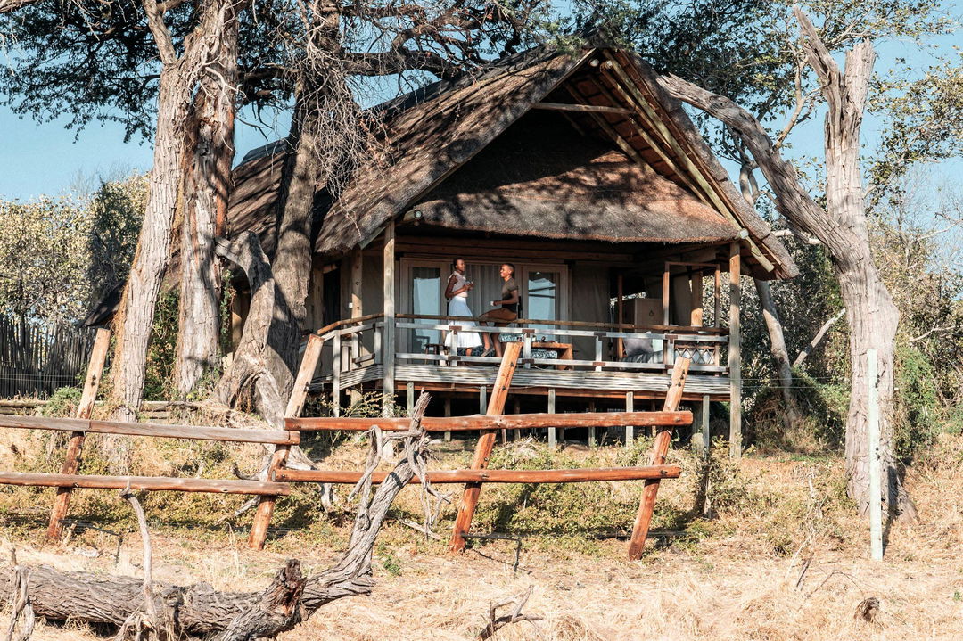 guests on deck of room at Savute elephant lodge Belmond