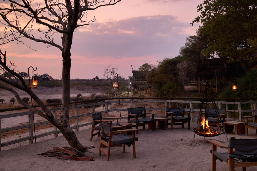boma with fireplace at sunset overlooking delta at Savute elephant lodge
