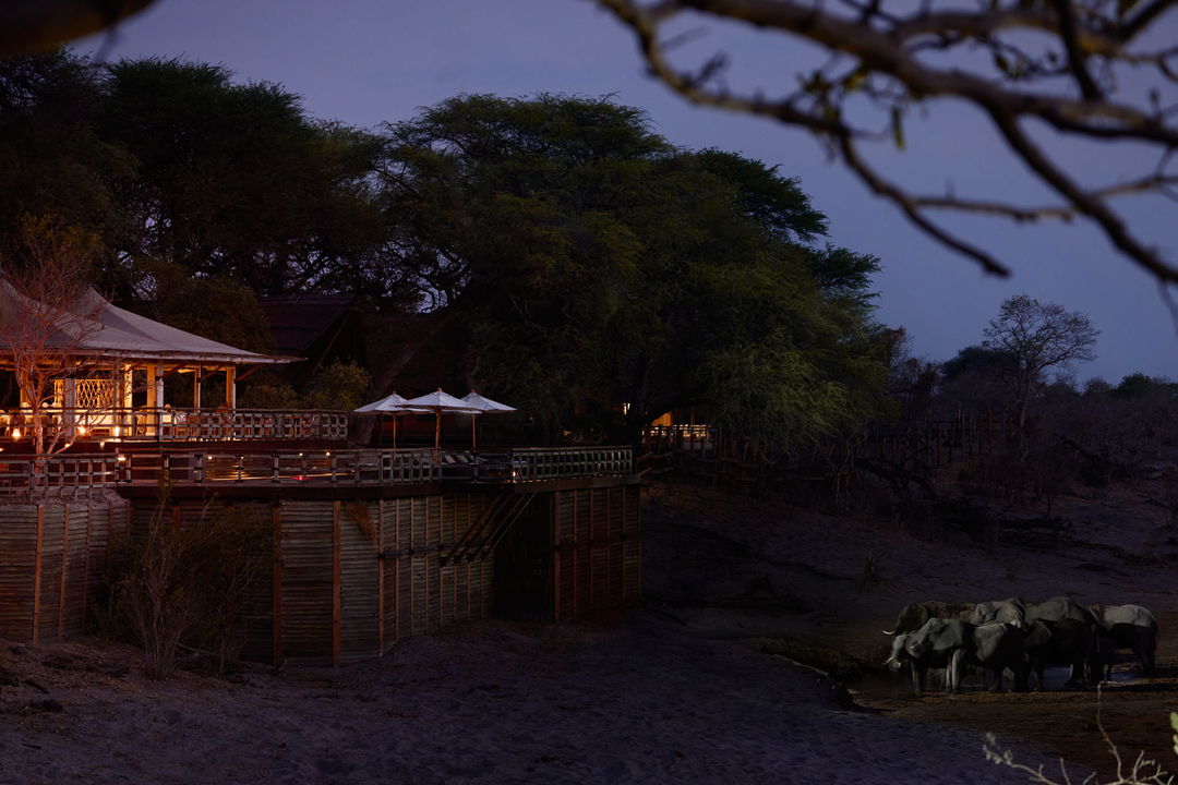 sunset view of lodge from delta at night at Savute elephant lodge Belmond