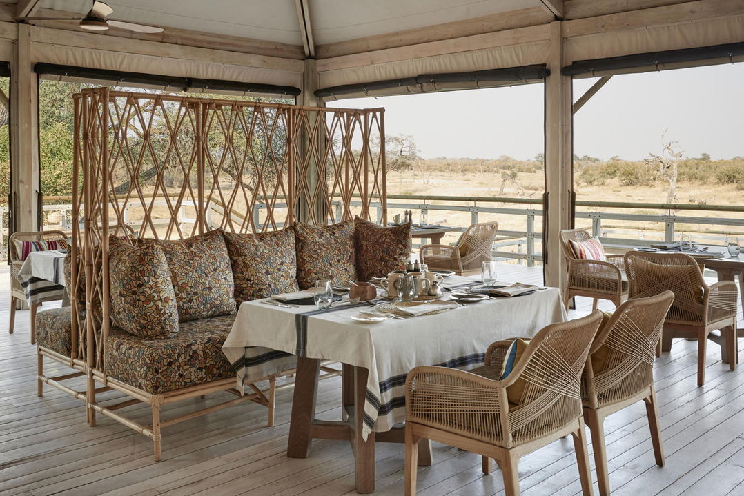 table and chairs set for lunch on deck at Savute elephant lodge Botswana