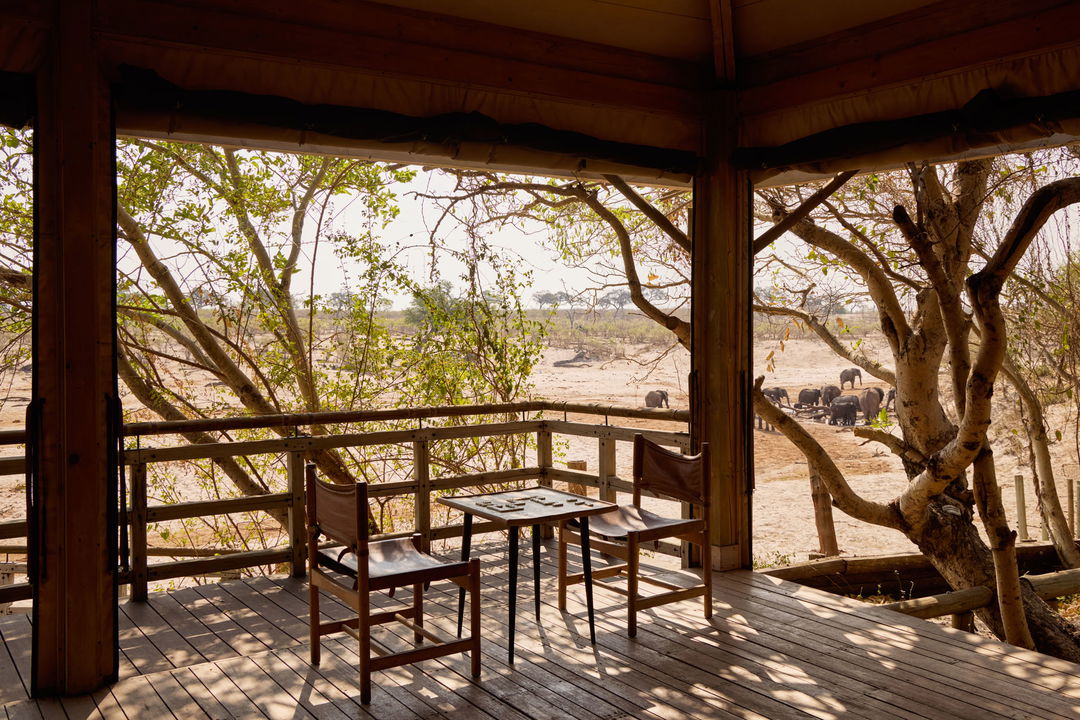 table and chairs on deck with view of Delta at Belmond Safaris Savute Elephant lodge Botswana
