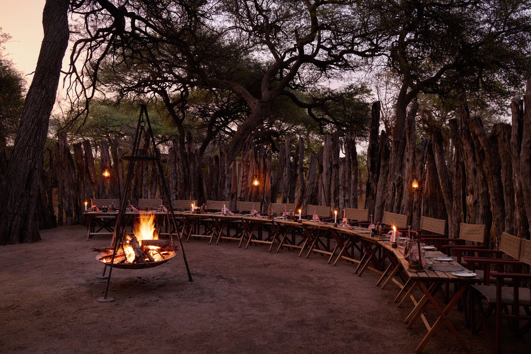 boma fireplace with lanterns at sunset Savute elephant lodge Botswana