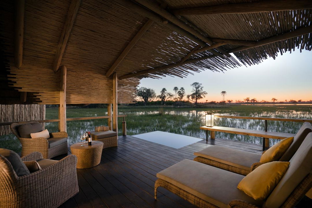 viewing deck with sofas showing pool and delta at eagle island lodge by Belmond