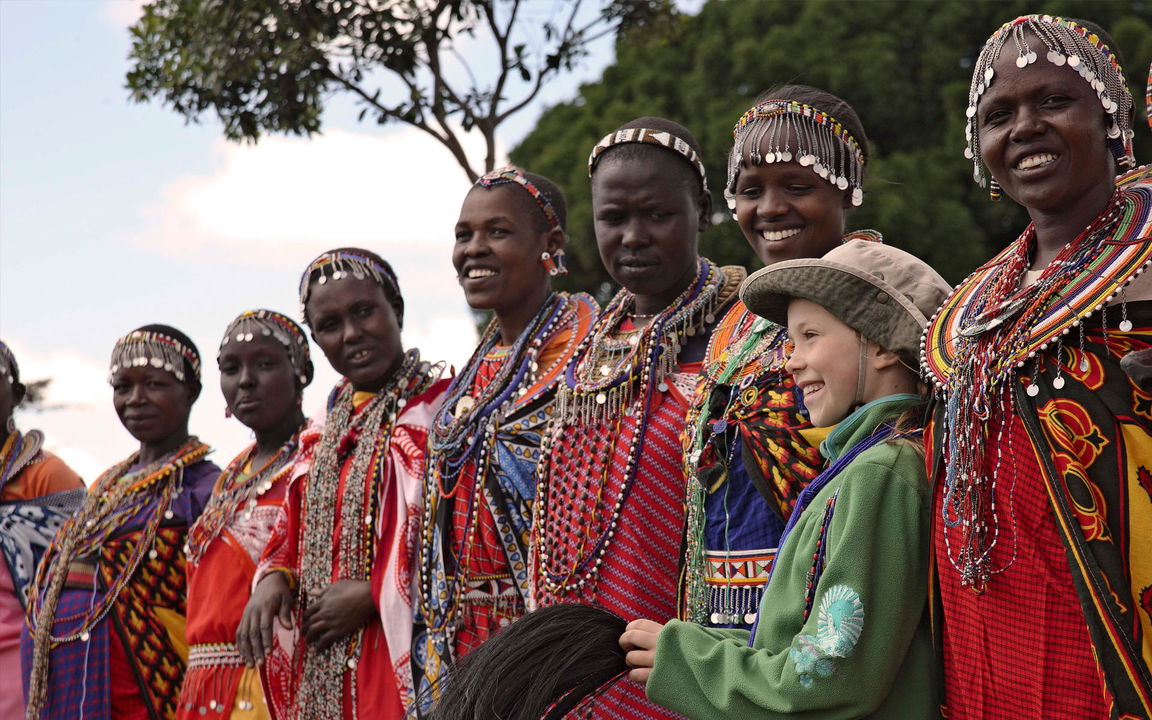Masai tribe and guest on cultural visit of andbeyond Bateleur camp Kenya Masai Mara