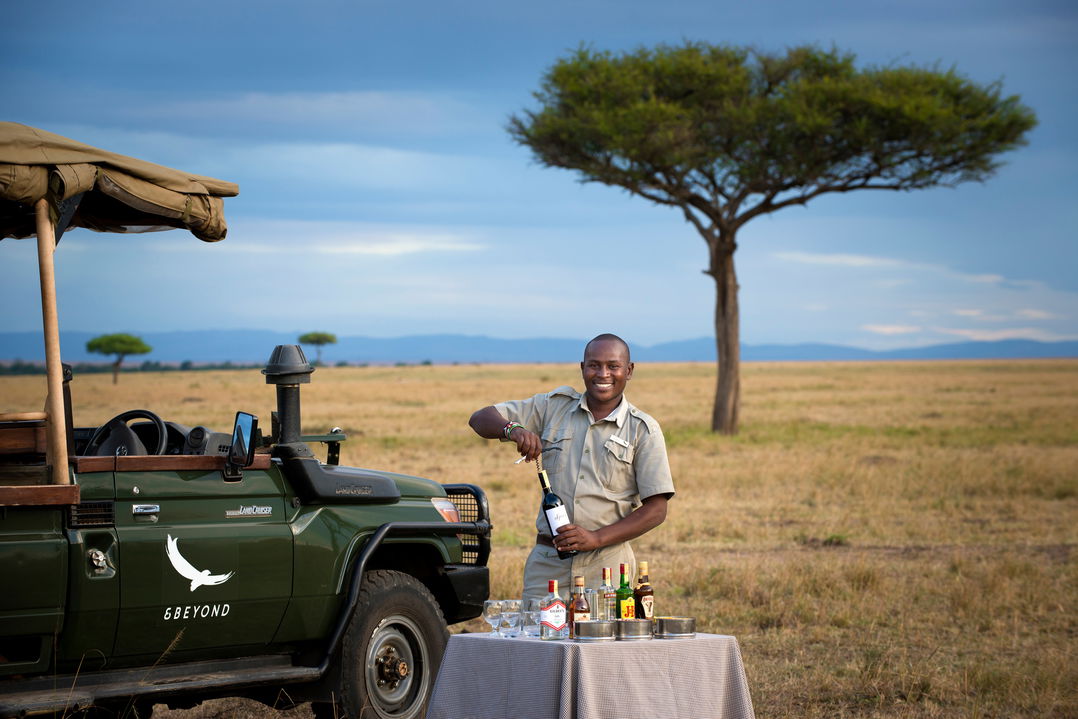 sundowners by safari vehicle on plains of andbeyond Bateleur camp Kenya Masai Mara