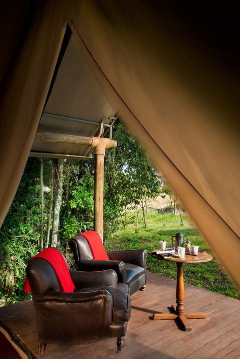 coffee table and chairs outside room at andBeyond Kichwa Tembo Camp Kenya Masai Mara