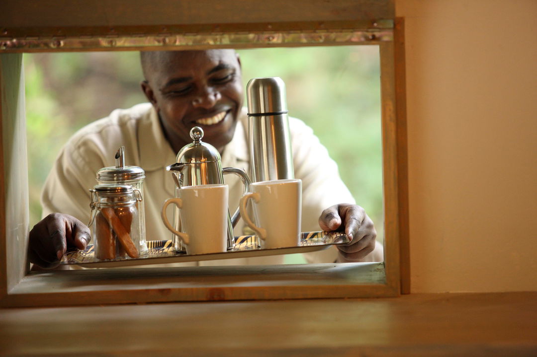 coffee served by butler in tented suite of andBeyond Kichwa Tembo Camp Kenya Masai Mara
