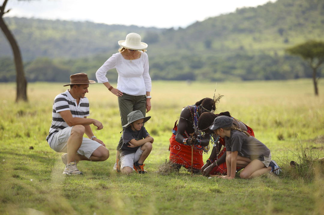 family on a bush walking safari at andBeyond Kichwa Tembo Camp Kenya Masai Mara