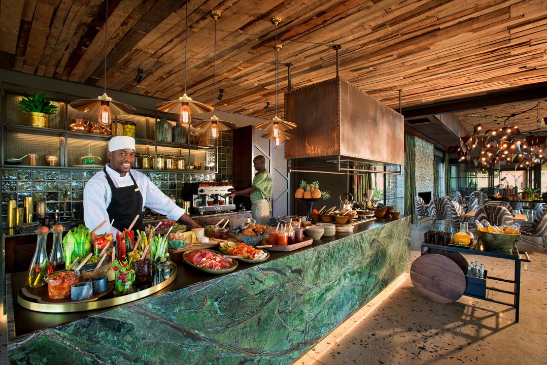 chef at counter with food spread at &Beyond Tengile River Lodge Sabi Sands