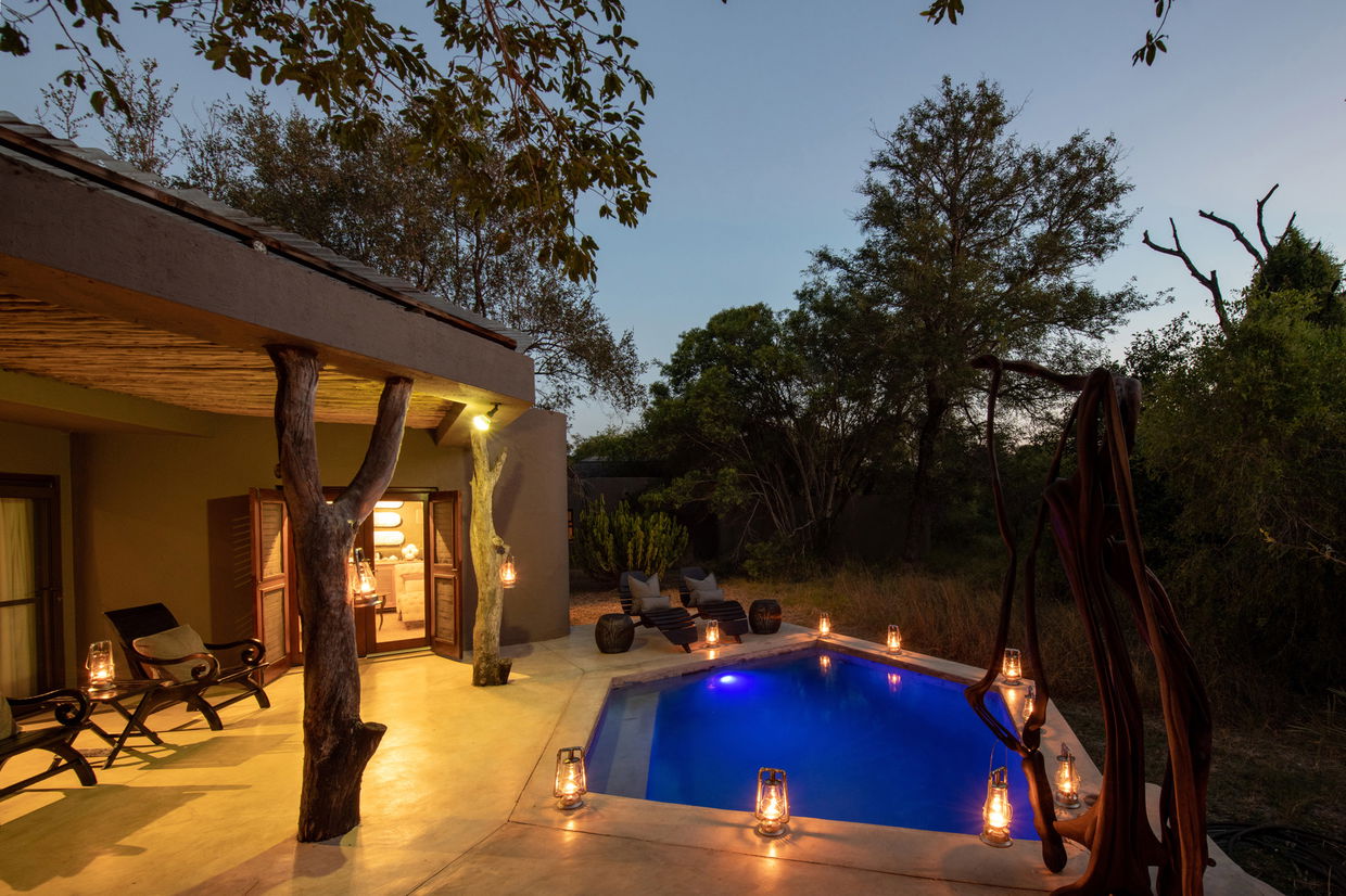 view of patio and pool at sunset by sabi sabi bush lodge