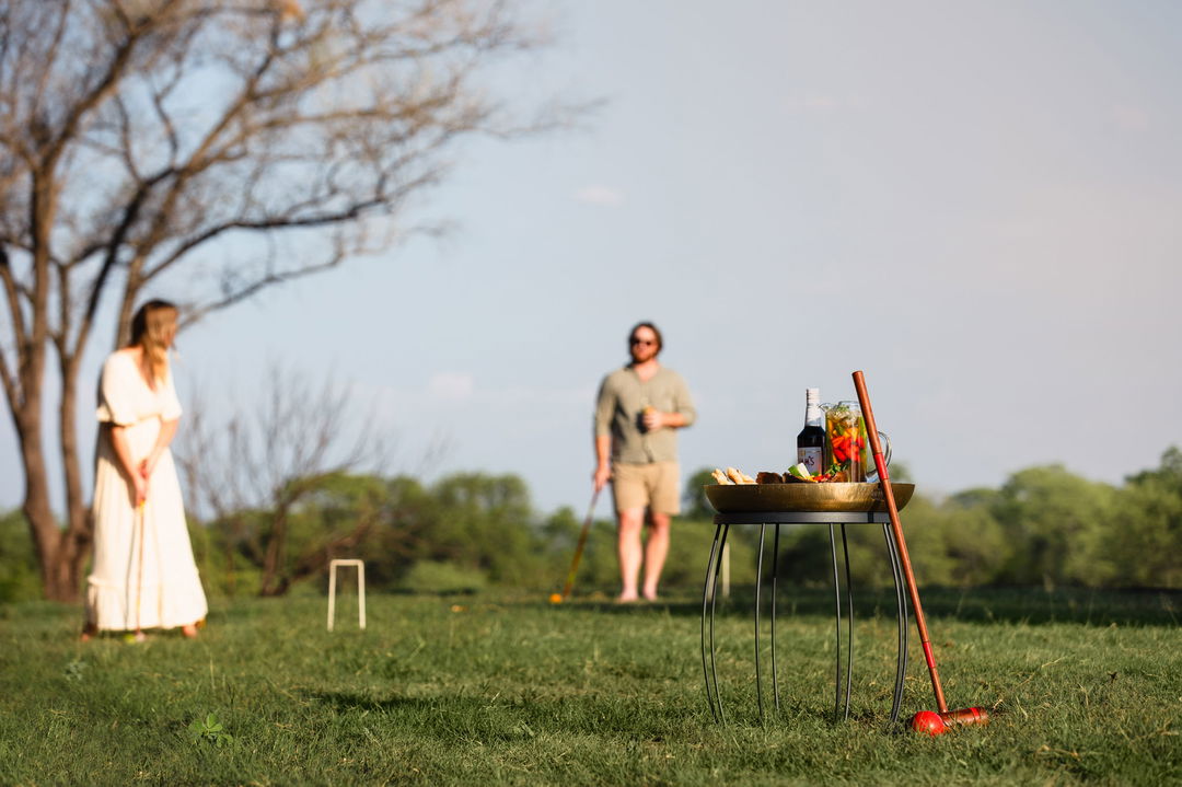 couple playing croquet at chichele presidential lodge