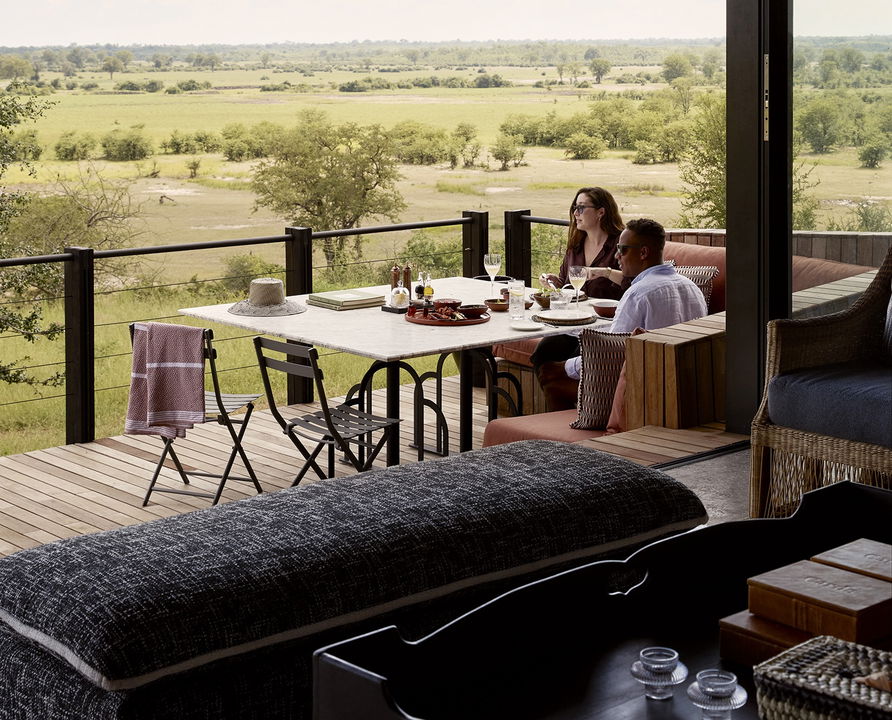 couple dining on deck of Chichele Presidential Camp Luangwa Plains Zambia