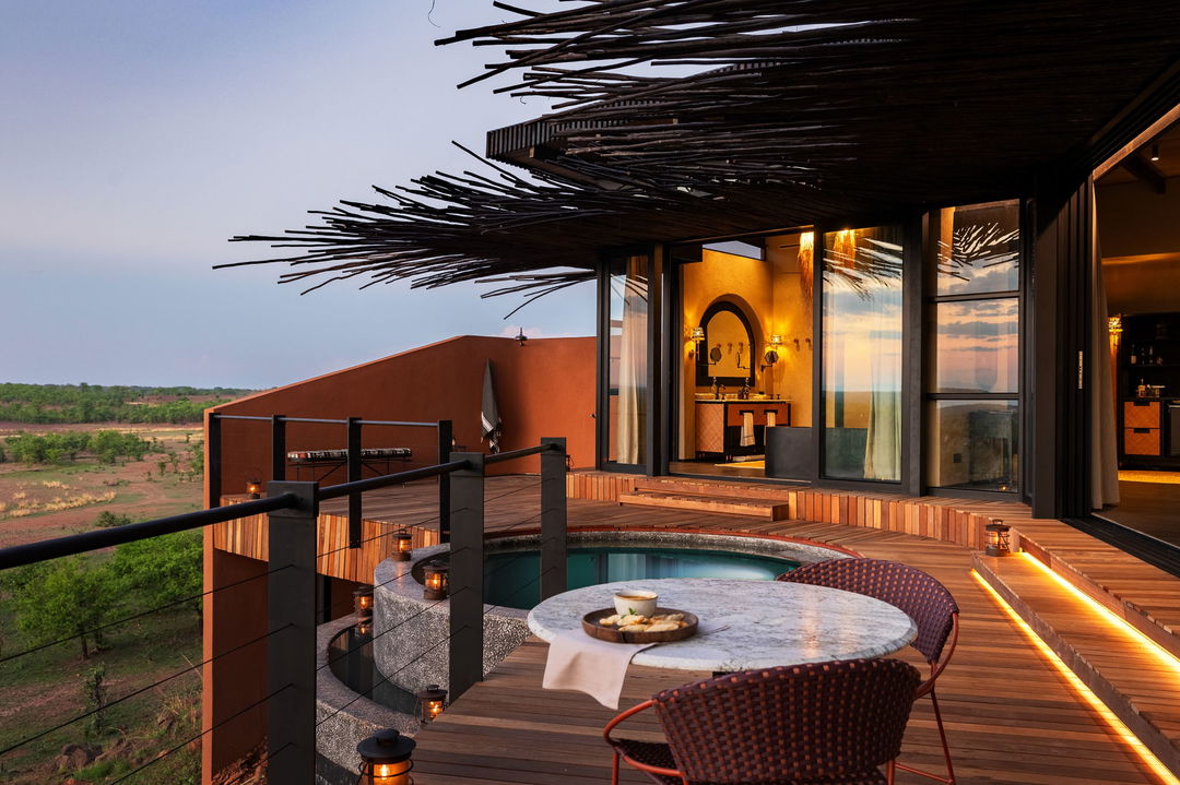 view of deck and room of suite at sunset by Chichele Presidential Camp Zambia