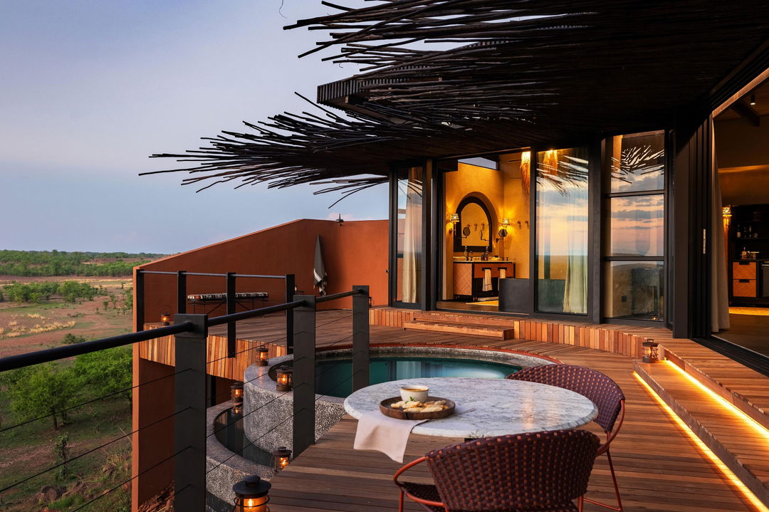 view of deck and room of suite at sunset by Chichele Presidential Camp Zambia