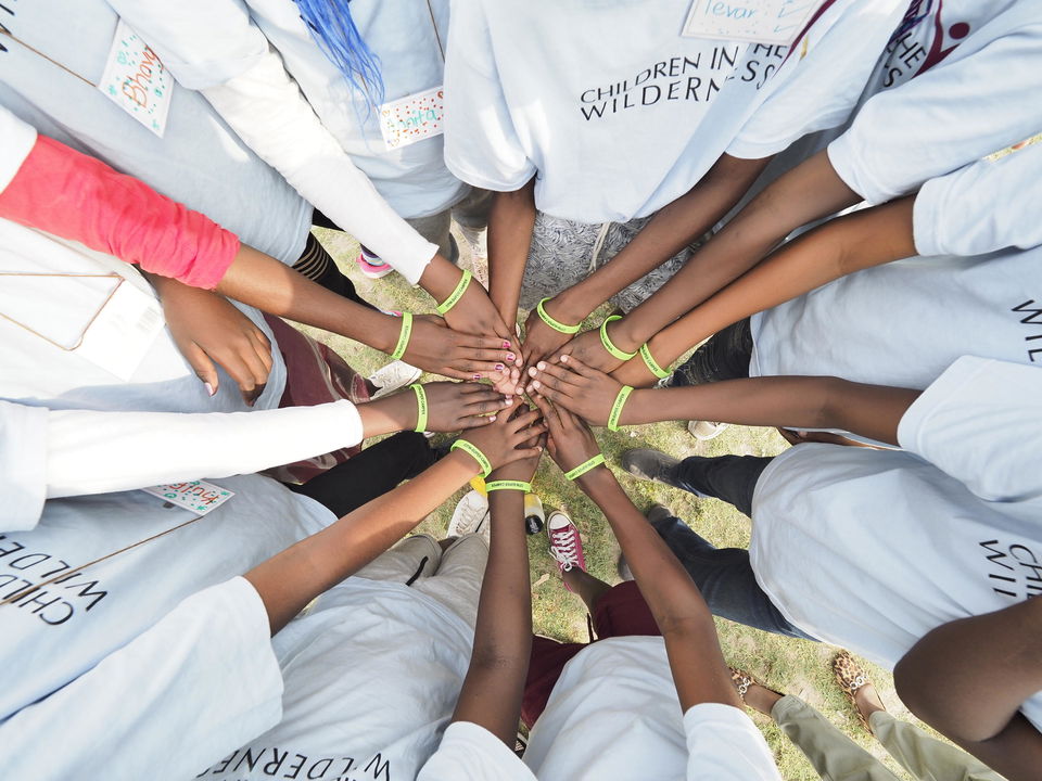 hands in star formation from above at cultural village at Vumbura Plains Camp Wilderness Okavango Delta