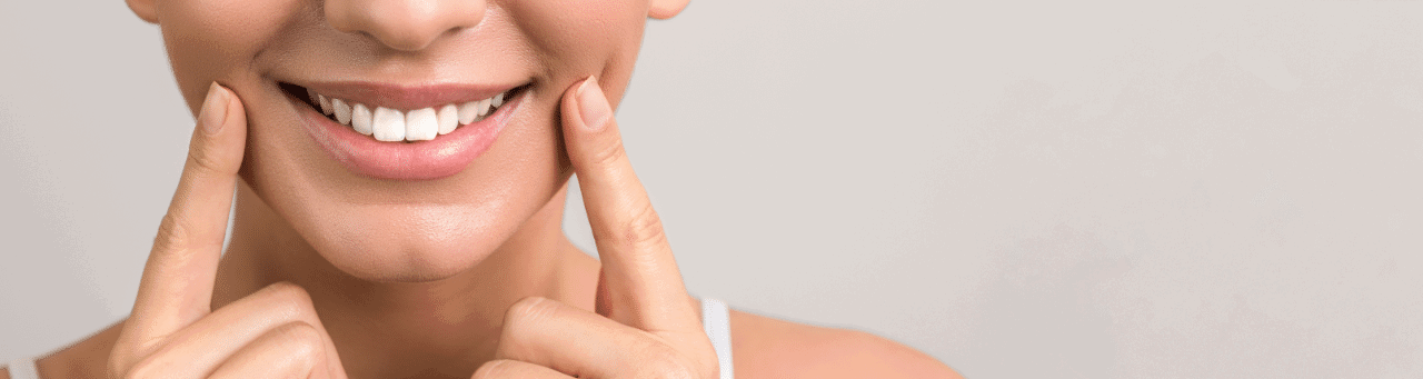 lady smiling and pulling lips to reveal smile