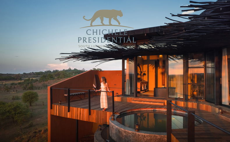 lady on deck of vista suite looking out over plains at sunset by Chichele Presidential Lodge Zambia with logo overlay 