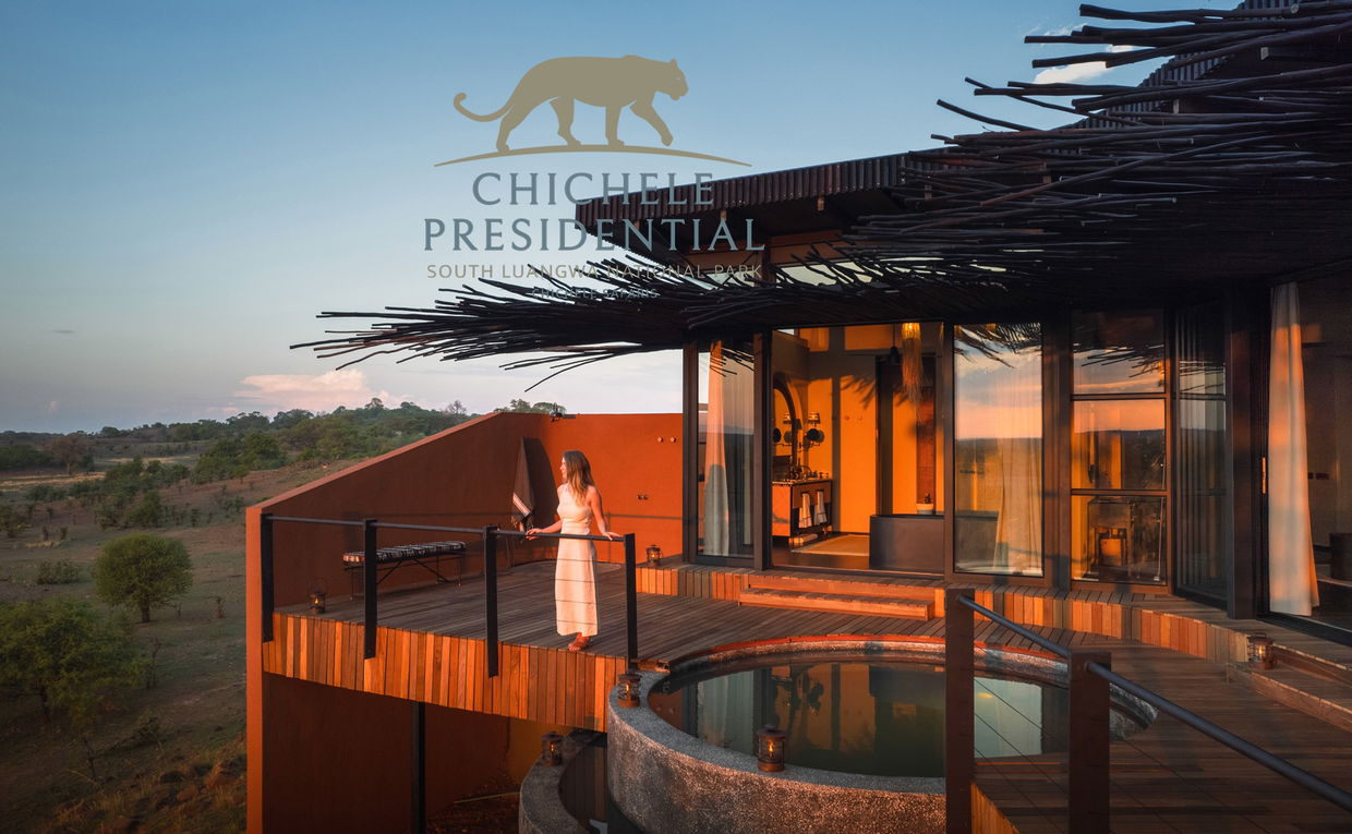 lady on deck of vista suite looking out over plains at sunset by Chichele Presidential Lodge Zambia with logo overlay 