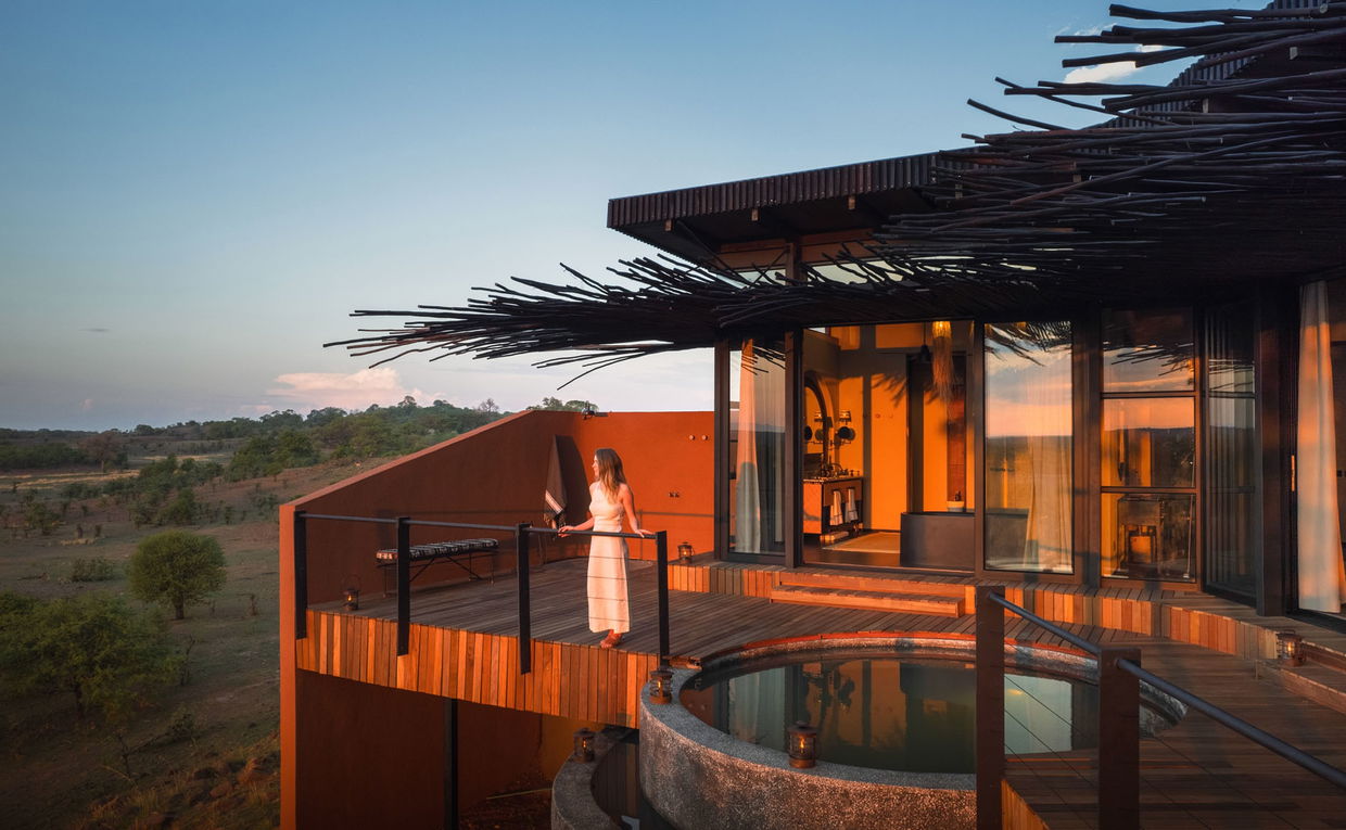 lady on deck of vista suite looking out over plains at sunset by Chichele Presidential Lodge Zambia lady on deck of vista suite looking out over plains at sunset by Chichele Presidential Lodge Zambia