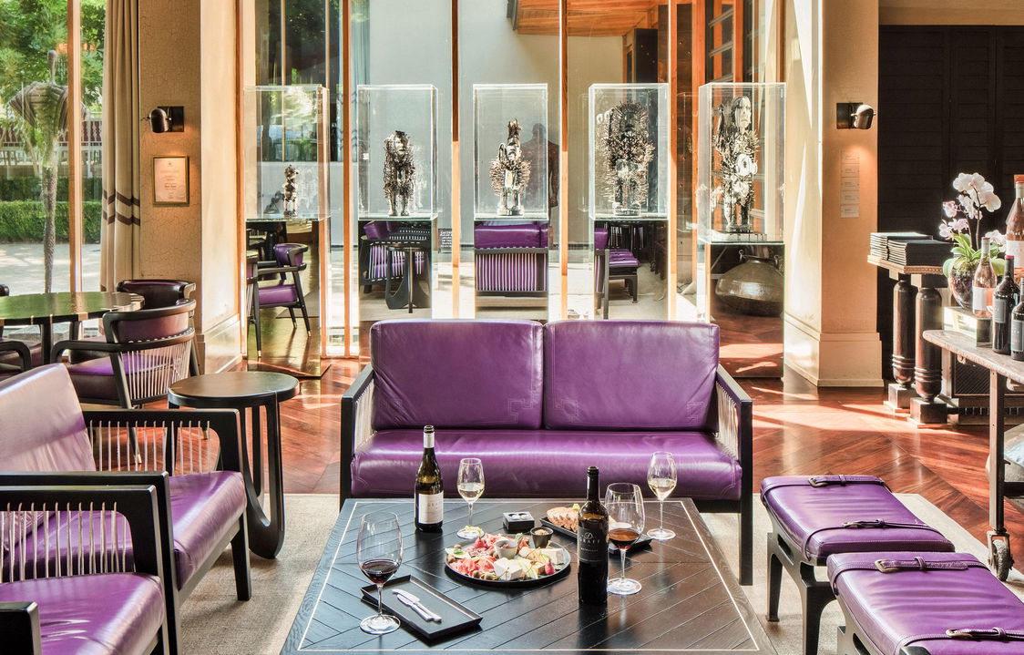purple couch in reception with table full of snacks and wine at Delaire Graff luxury Wine estate in Franshoek