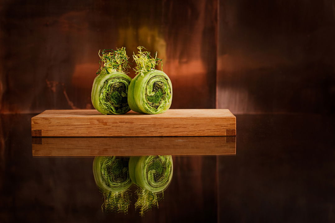 two green sushi rolls on wooden board at Delaire Graff luxury Wine estate in Franshoek