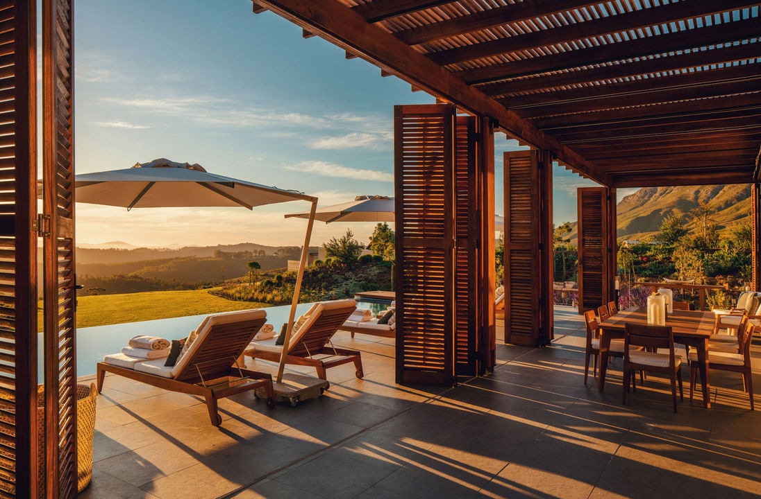 views of patio and pool from luxury room of owners villa at Delaire Graff luxury Wine estate in Franshoek
