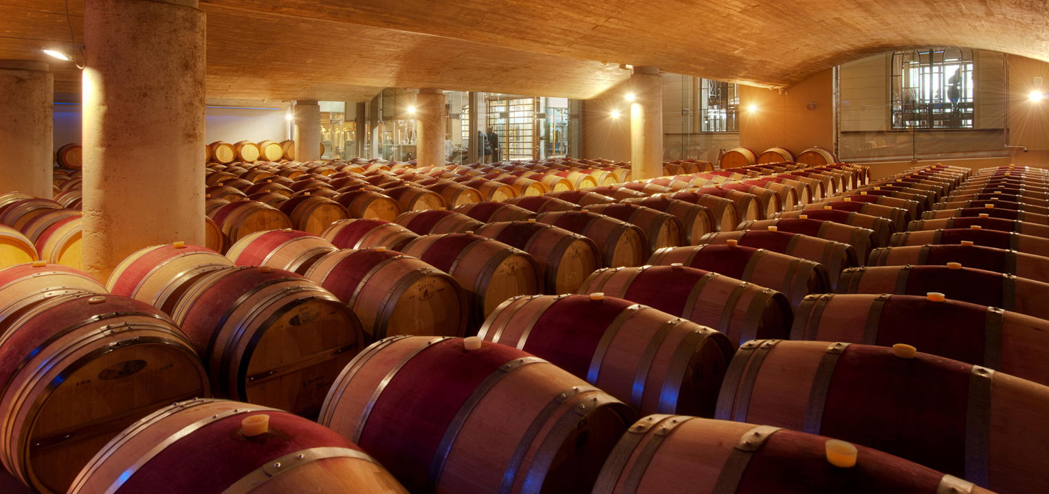 wine barrels in rows on floor of wine cellar at Delaire Graff luxury Wine estate in Franshoek