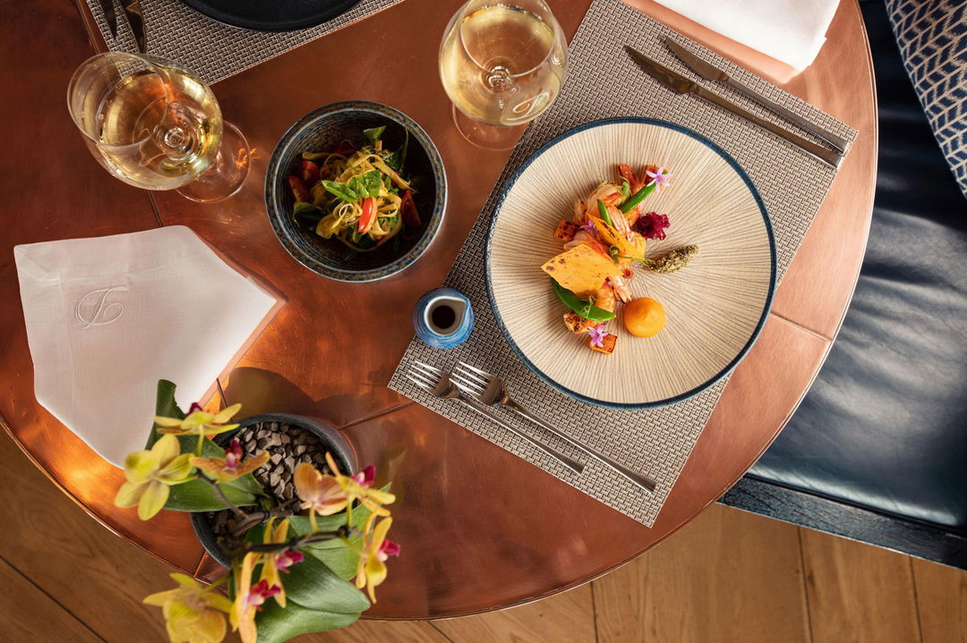 table set with gourmet dishes in plates at Delaire Graff luxury Wine estate in Franshoek