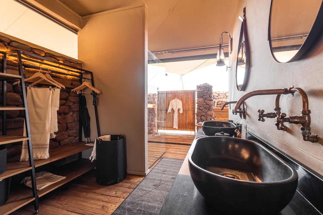 bathroom and shower view of room at desert rhino camp wilderness Namibia 