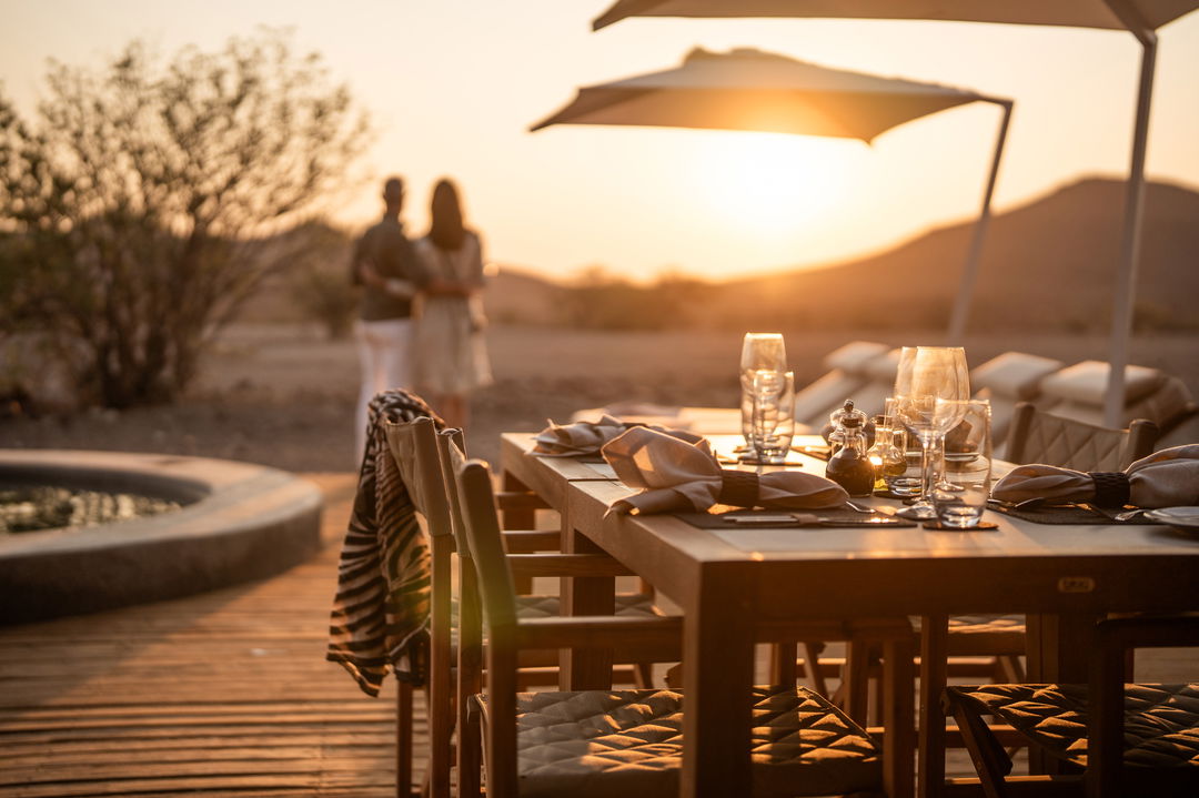 table set for romantic dinner at desert rhino camp wilderness Namibia