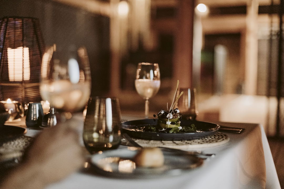 cousine served on table with wine at Vumbura Plains Camp Wilderness Okavango Delta