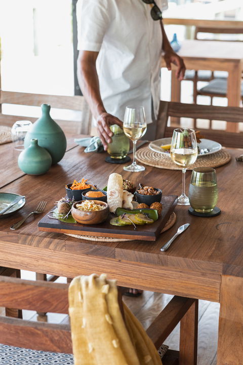 plates with food on table at Vumbura Plains Camp Wilderness Okavango Delta