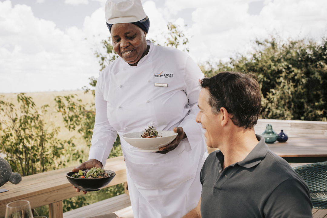 chef serving guess food at Vumbura Plains Camp Wilderness Okavango Delta