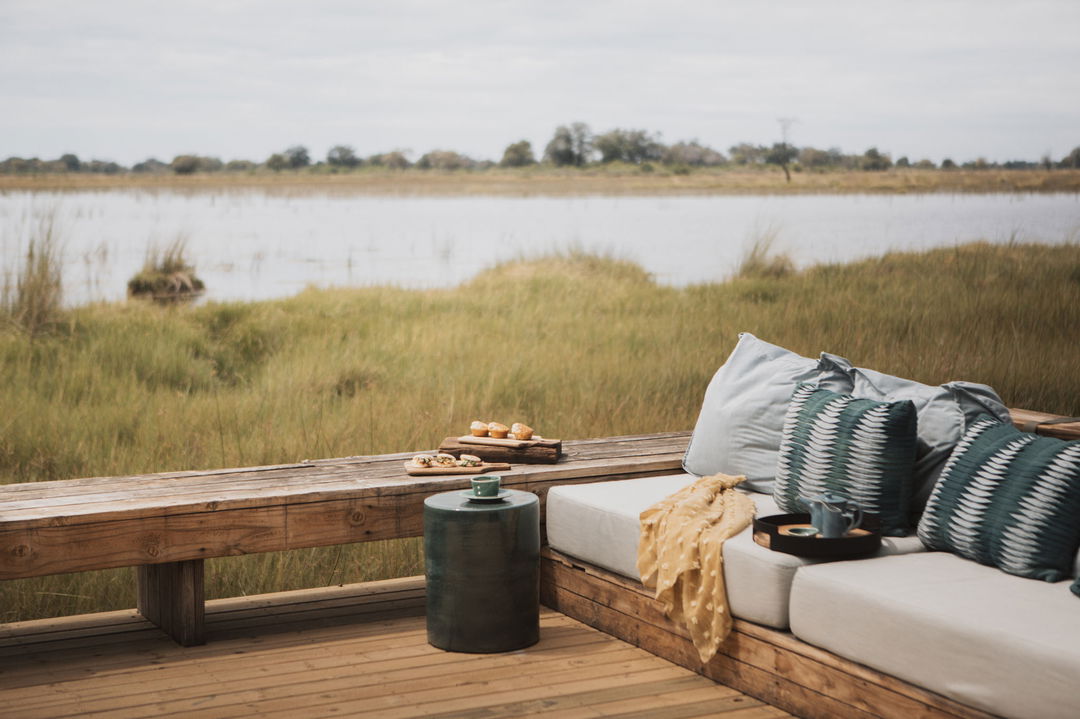 viewing deck with bench and water in background at Vumbura Plains Camp Wilderness Okavango Delta