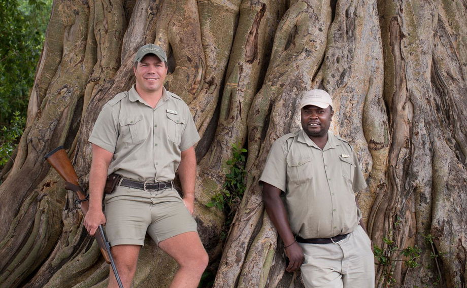 two rangers standing by tree at &Beyond Tengile River Lodge Sabi Sands