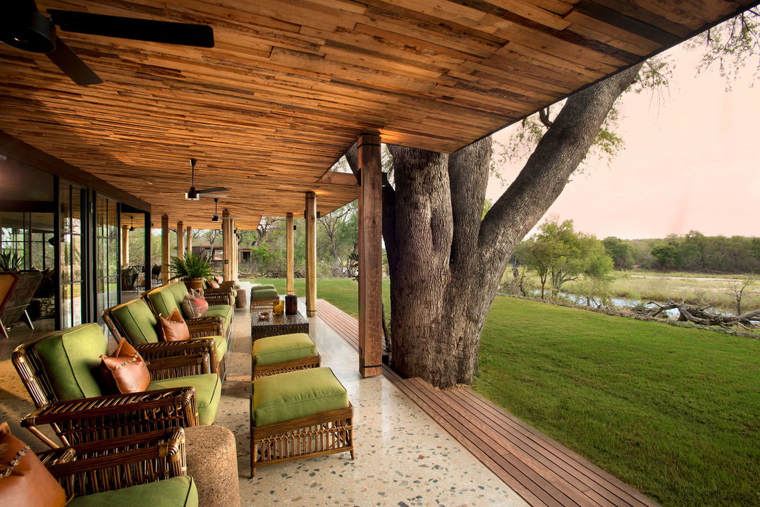 outside view of deck with loungers at &Beyond Tengile River Lodge Sabi Sands